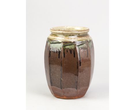RICHARD BATTERHAM (1936-2021); a tall cut sided stoneware jar covered in tenmoku and green ash glaze, height 23.5cm. (D)Addit