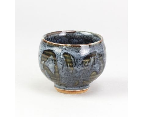 NICK REES (born 1949) for Muchelney Pottery; a stoneware yunomi covered in dark green glaze with blue/grey decoration, impres