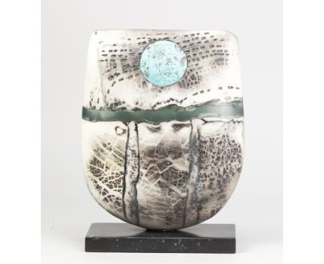 PETER HAYES (born 1946); a raku bow with fractured smoky surface, jade green wave and copper patina disc, mounted on slate ba