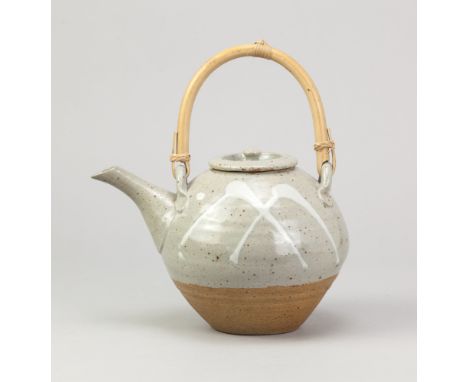 WILLIAM MARSHALL (1925-2007) for Leach Pottery; a stoneware teapot with cane handle partially covered in grey glaze with trai