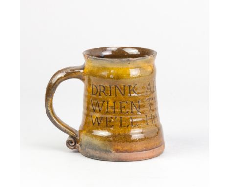 Attributed to MICHAEL CARDEW (1901-1983) for Leach Pottery; a slipware calligraphic mug with scroll handle covered in galena 