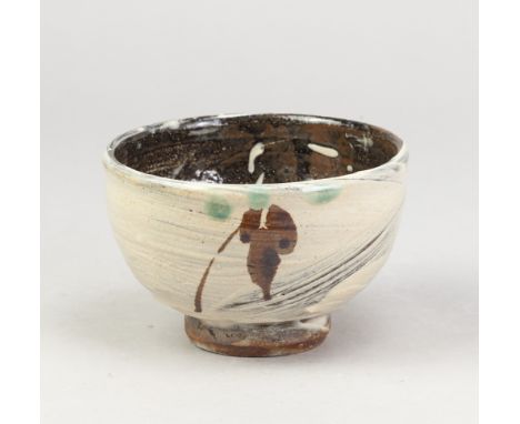 JIM MALONE (born 1946); a stoneware chawan covered in hakeme glaze with iron decoration and copper green spots, impressed JM 