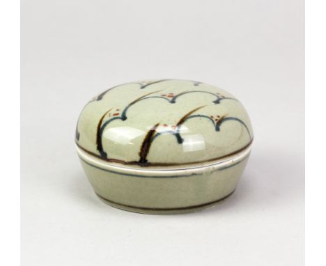 DAVID LEACH (1911-2005) for Lowerdown Pottery; a porcelain box and cover covered in celadon glaze with cobalt wave and copper