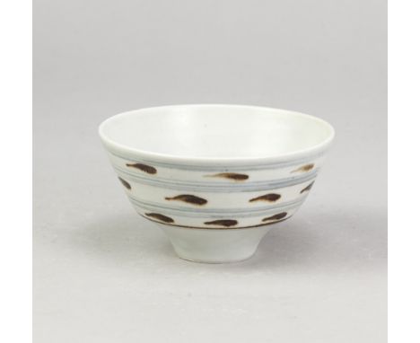 DAVID LEACH (1911-2005) for Lowerdown Pottery; a small porcelain bowl covered in celadon glaze with iron and cobalt decoratio