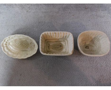Three Victorian ceramic jelly moulds with pineapple, turkey and fish motifs. H.10cm 
