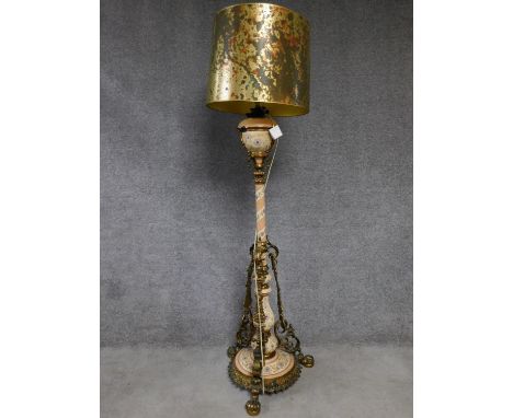 A ceramic and brass tall standard lamp with gilded and hand painted floral design. H.178cm 