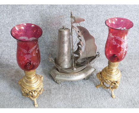 A pair of antique lamps and pierced metal galleon lantern. The oil lamps have engraved lustre cranberry glass shades, the bas