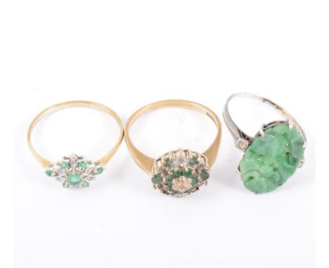 Two diamond and emerald rings in 9 carat yellow and white gold, ring sizes T, and a carved jade ring in an all white metal ri