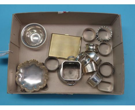 An engine-turned silver-gilt cigarette case, three small silver dishes, two-handled silver bottle holder and eleven various s