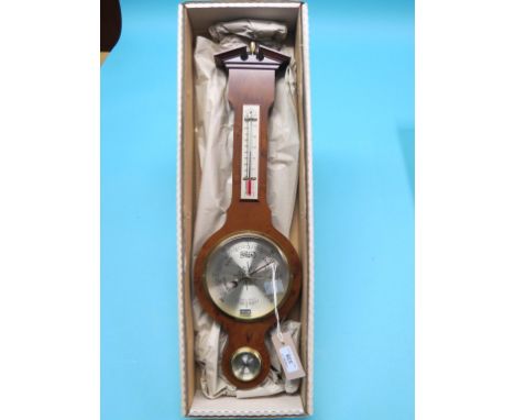 A reproduction wheel barometer by Comitti, with silvered dials, burr yew case with break-arch pediment