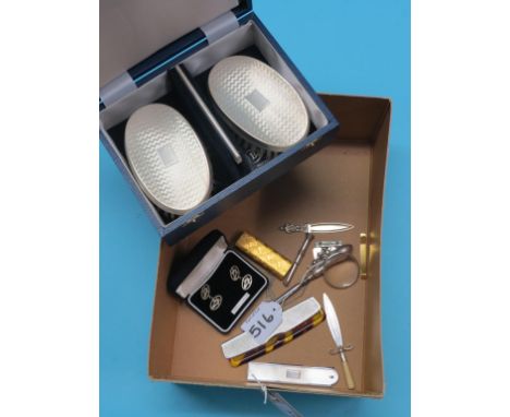 A cased pair of engine-turned silver clothes brushes, two engine-turned silver-mounted combs, two pairs of silver cuff-links,