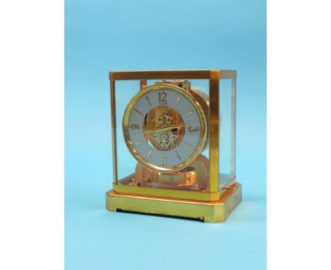 A Jaeger Le Coultre Atmos clock, exposed perpetual motion movement and 4.75in. white chapter ring, in locking, glazed gilt-br
