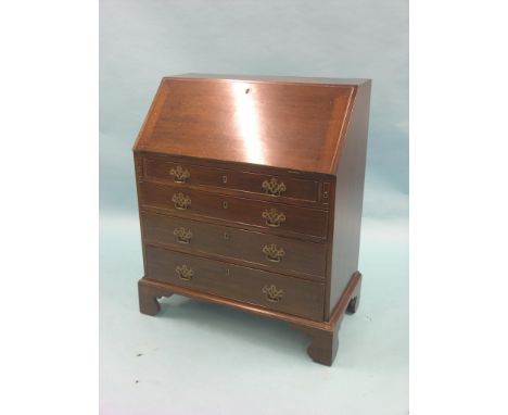 A Victorian mahogany bureau, stepped interior with central cupboard and columnar document drawers, four long graduated drawer
