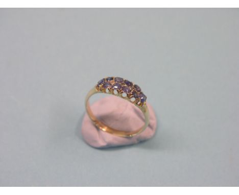 A yellow metal half-hoop ring, set ten Ceylon sapphires, size R