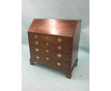 A George III mahogany bureau, fall-front with incised border, fitted interior consists of eight pigeon-holes and seven short 