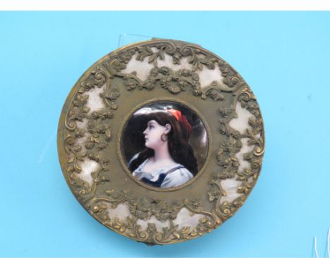 A 19th century French gilt-brass circular box, hinged cover inset with a Limoges enamel on copper portrait roundel, young fem