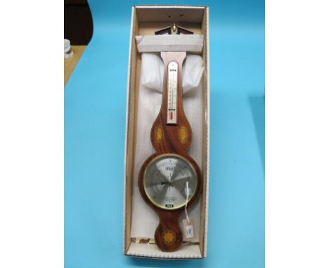 A reproduction wheel barometer by Comitti, case inlaid with shells, break-arch pediment