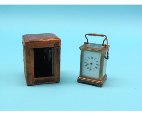 An early 20th century French carriage clock, with enamelled dial and gong-striking movement, with key, in original travelling