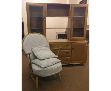 An Ercol light elm sideboard, with raised, glazed cabinets, cupboard base with three drawers, 5ft. 1in. wide, together with a