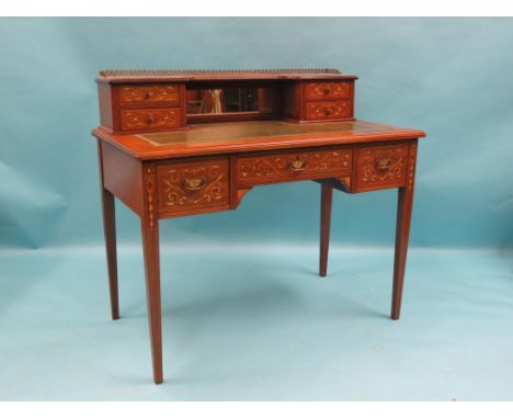 A Victorian inlaid rosewood writing table, ormolu-mounted over-shelf with four short drawers and central mirror, inset gilt-t