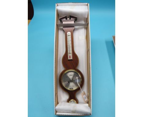 A reproduction wheel barometer by Comitti, with silvered dials, mahogany case with inlaid stringing, break-arch pediment