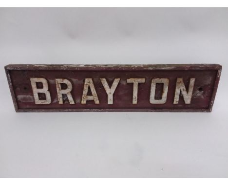 (cast letters on wooden back board)