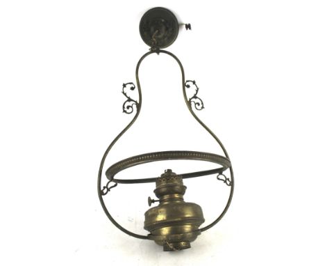 A vintage brass oil lamp converted into a ceiling light. H60cm. Missing shade