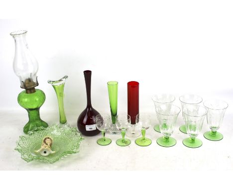 A collection of assorted vintage coloured glassware.  Including a green glass oil lamp, red glass vase, etc. Max. H39cm