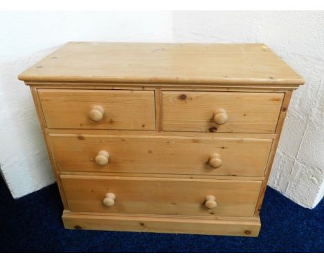 A low level pine chest with four drawers, 33.75in wide x 28in high x 17.75in deep