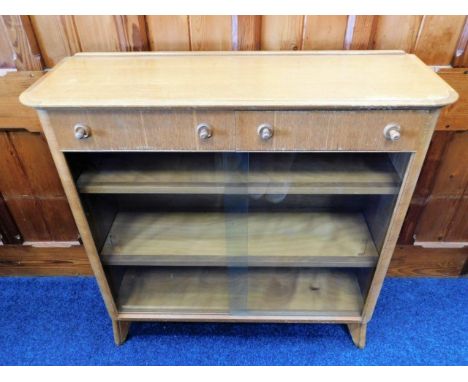 A mid 20thC. retro oak book case with two drawers &amp; sliding glass doors, 38in wide x 37.75in high x 13in deep 