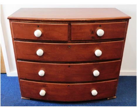 A Victorian stained pine chest of drawers with porcelain handles, 42.5in wide x 36.5in high x 21.5in deep 
