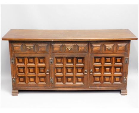 A 20thC. oak sideboard with three cupboards &amp; three drawers, 62in wide x 29.125in high x 18.375in deep