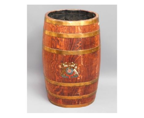 An oval shaped, coopered oak stick stand with brass fittings &amp; coat of arms to front, 24.5in high x 13.25in wide x 10.25i