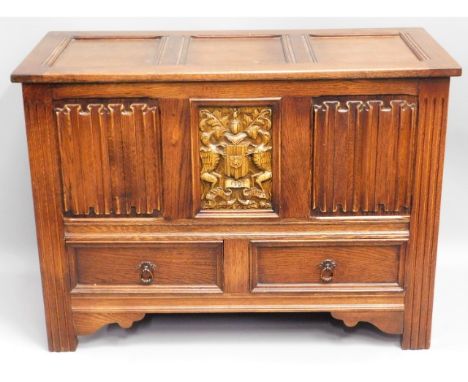 An oak blanket box with linenfold &amp; coat of arms decor with two drawers under, 38.75in wide x 28in high x 17.625in deep