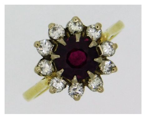 An 18ct gold ring set with approx. 0.5ct diamond &amp; centre ruby of 6.25mm diameter, 4.1g, size L 