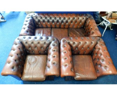A brown leather Chesterfield style three piece suite, sofa 77in wide