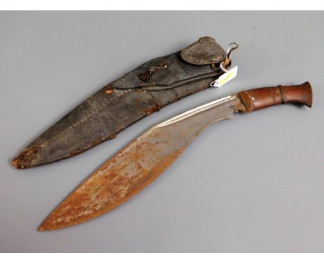 A kukri knife with leather scabbard &amp; wooden handle, 17.25in long, a/f