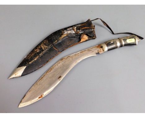 A kukri knife with leather scabbard &amp; horn handle with lion mask finial, 17.75in long, a/f