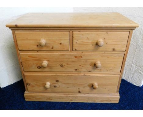 A low level pine chest with four drawers, 33.75in wide x 28in high x 17.75in deep 