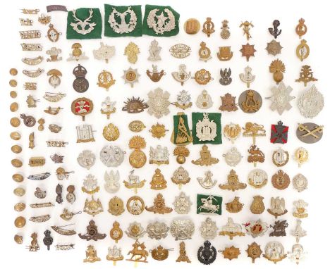 Ninety-seven military cap badges, mainly British army and Canadian army, together with other titles, buttons, badges and unif