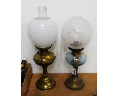 An early 20th century brass pedestal oil lamp having an opalescent globular shade, and blue tinted font, together with one ot