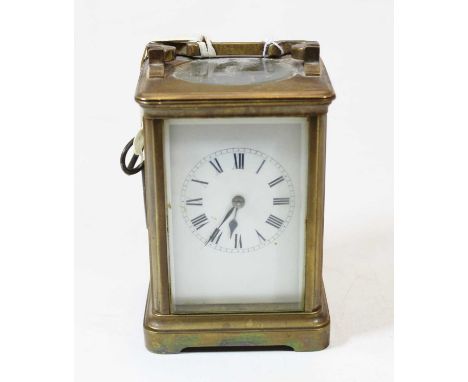 An early 20th century lacquered brass carriage clock having an enamel dial with Roman numerals, visible platform lever escape