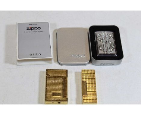A Zippo pocket cigarette lighter embossed with a dollar sign in Zippo tin and card outer sleeve (new), together with a Dunhil