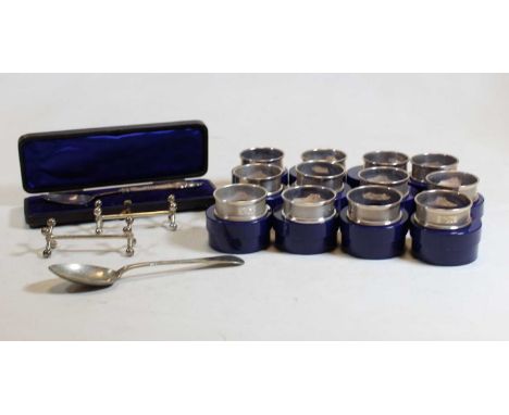 A set of 12 modern silver napkin rings, each having engine turned decoration and initialled 'G', in plastic case, gross weigh