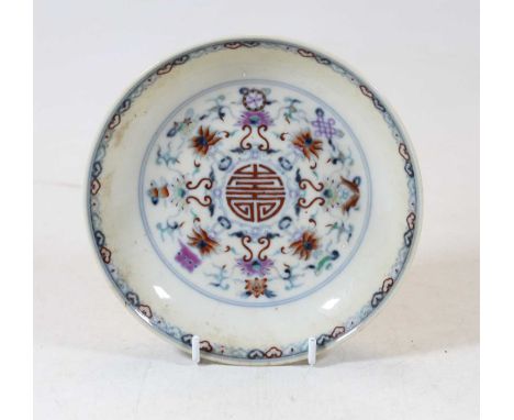 A Chinese export porcelain shallow bowl, the centre enamel decorated with flowers in shades of red, purple and blue, having a