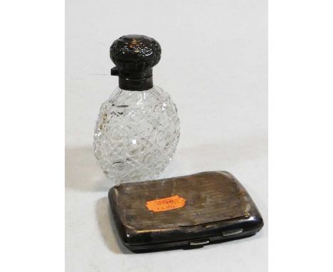 An Edwardian cut glass scent bottle having a silver cap; together with a Georg V silver pocket cigarette case (2)