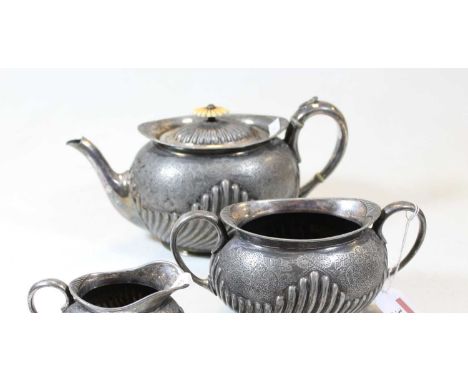 A Victorian pewter three piece tea service, with half gadrooned decoration