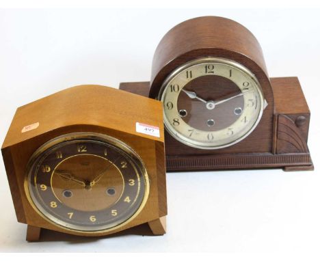 A 1950s oak cased mantel clock having a silvered chapter ring with Arabic numerals and chiming movement, together with one ot