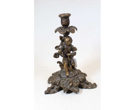 An early 20th century German patinated spelter figural table candlestick, with foliate decoration, h.29cm