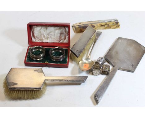 An Art Deco style engine turned silver backed dressing table set to include hand mirror, hand brush, hair brush, and comb, to